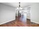 Dining room with wood floors, chandelier, and an open view into the living area at 319 Harvard Dr, Albemarle, NC 28001