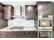 Close-up of the kitchen's stainless steel Bosch oven, gas cooktop, and granite countertop at 319 Harvard Dr, Albemarle, NC 28001