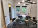 Dining room with access to a back deck, featuring a round dining table and modern light fixture at 327 Coxe Ave, Charlotte, NC 28208