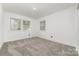 Bright, empty bedroom with neutral carpet and multiple windows at 3619 Bankston Pl, Charlotte, NC 28215