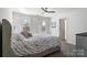 Large, bright bedroom with floral bedding and a ceiling fan at 4551 Selhurst Dr, Indian Land, SC 29707