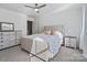 Well-lit bedroom with a beige upholstered bed, a dresser and two nightstands at 4551 Selhurst Dr, Indian Land, SC 29707