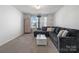 Living area with large gray sectional couch and white coffee table at 4551 Selhurst Dr, Indian Land, SC 29707