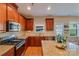 Modern kitchen featuring stainless steel appliances, granite countertops, and ample cabinet space at 815 Oak Embers Se Dr, Concord, NC 28025