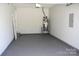 Empty garage with gray flooring and a water heater at 8412 Bristol Ford Pl, Charlotte, NC 28215