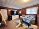 Living area with wood-paneled walls, a couch, a TV, and carpeted floors at 901 Skyland St, Kannapolis, NC 28083