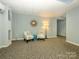 Condo lounge area with seating and carpet at 1300 Reece Rd # 411, Charlotte, NC 28209