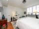 Main bedroom featuring hardwood floors, a workspace, and large windows at 1300 Reece Rd # 411, Charlotte, NC 28209