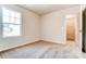 Empty bedroom featuring carpet, neutral walls, a window, and a closet at 14906 Tamarack Dr, Charlotte, NC 28278