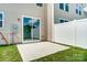 Concrete patio with sliding glass doors leading to the backyard at 14906 Tamarack Dr, Charlotte, NC 28278