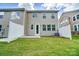 Fenced backyard with a small patio and green lawn, attached to a two-story home at 14914 Tamarack Dr, Charlotte, NC 28278