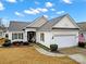 Beautiful one-story home with a two-car garage and well-manicured lawn at 15175 Legend Oaks Ct, Fort Mill, SC 29707