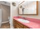 Bathroom with pink countertop, wooden cabinets, and tiled floor at 1599 Locustwood Ave, Lancaster, SC 29720