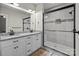 Modern bathroom with a dual vanity, granite countertops, and a glass-enclosed shower at 399 Spring St, Richfield, NC 28137