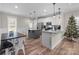 Open-concept kitchen and dining area with white cabinets, granite counters, and an island at 399 Spring St, Richfield, NC 28137