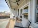 Covered back patio with ceiling fan, seating area and fenced in backyard at 4024 S Rocky River Rd, Monroe, NC 28112