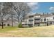 Spacious backyard with a grassy slope leading to a two-story home with balconies at 51 Old Post Rd, Lake Wylie, SC 29710