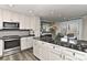 Modern kitchen with white cabinets, black granite countertops, and stainless steel appliances at 51 Old Post Rd, Lake Wylie, SC 29710