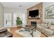 Living room with stone fireplace and comfy seating at 5361 Harvest Hill Dr, Harrisburg, NC 28075