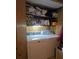 Laundry room with a stacked washer and dryer unit, shelves, and storage space at 72 Marshdale Sw Ave, Concord, NC 28025