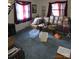 Living room with blue carpet, large windows, and ample natural light at 72 Marshdale Sw Ave, Concord, NC 28025