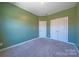 Bedroom with soft green walls, white trim and door, and plush carpeting at 739 Bethesda Rd, Statesville, NC 28677