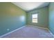 Bright green bedroom with plush carpeting and a large window for natural light at 739 Bethesda Rd, Statesville, NC 28677