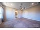 Bedroom featuring plush carpet, an open doorway leading to the bathroom, and another door to the adjacent room at 739 Bethesda Rd, Statesville, NC 28677