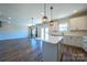 Bright, open kitchen and dining area with white cabinets, island, and modern light fixtures at 739 Bethesda Rd, Statesville, NC 28677