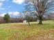 Large backyard with outbuildings, mature trees, and plenty of open space at 823 Candy Dr, Statesville, NC 28677