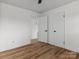 Empty bedroom featuring wood-look flooring, white walls, and an open door at 823 Candy Dr, Statesville, NC 28677