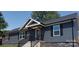 Gray house with black shutters, stone accents, and a covered porch at 6215 Faith Rd, Salisbury, NC 28146
