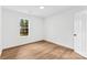 Spacious bedroom with wood flooring and a window offering natural light at 10112 Santa Fe Ln, Mint Hill, NC 28227