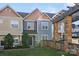 Inviting townhome with a charming front porch and well-maintained landscaping at 10346 Mcgoogan Ln, Charlotte, NC 28277