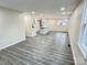 Spacious living area with wood-look flooring and an open view to the kitchen at 1057 Gaither Nw Pl, Concord, NC 28027