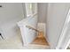 Modern light-colored staircase with wooden steps and neutral wall tones at 12239 Monteith Grove Dr, Huntersville, NC 28078