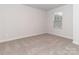 Empty bedroom with a window, neutral beige walls and carpet at 1244 31St St # 6, Conover, NC 28613