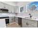 Stylish kitchen featuring gray shaker cabinets, a honeycomb backsplash, and stainless steel appliances at 126 Hemphill Ave, Chester, SC 29706