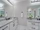 Double vanity bathroom with granite countertops and a large mirror at 1308 Pleasant Plains Rd, Matthews, NC 28105
