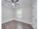Bright bedroom featuring hardwood floors and a ceiling fan at 1308 Pleasant Plains Rd, Matthews, NC 28105