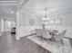 Bright dining room with chandelier and hardwood floors at 1308 Pleasant Plains Rd, Matthews, NC 28105