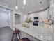 Modern kitchen with white cabinets and granite island at 1308 Pleasant Plains Rd, Matthews, NC 28105