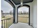 Covered porch with arched entryway and view of street at 1308 Pleasant Plains Rd, Matthews, NC 28105