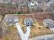 Aerial view of three homes with driveways and surrounding trees at 1312 Pleasant Plains Rd, Matthews, NC 28105