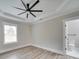 Bright bedroom featuring a ceiling fan and hardwood floors at 1312 Pleasant Plains Rd, Matthews, NC 28105