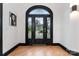 Grand entry with arched black door and decorative glass at 18805 Flat Shoals Dr, Cornelius, NC 28031