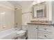Bathroom with tiled shower/tub combo, granite vanity top, and a framed mirror at 20105 Henderson Rd # J, Cornelius, NC 28031