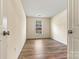Bedroom with wood-look flooring and large window at 20105 Henderson Rd # J, Cornelius, NC 28031