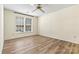 Bedroom with two large windows, wood-look flooring, and a ceiling fan at 20105 Henderson Rd # J, Cornelius, NC 28031
