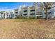 Apartment building exterior with balconies and a grassy lawn at 20105 Henderson Rd # J, Cornelius, NC 28031